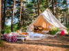 tent in bright forest with chairs